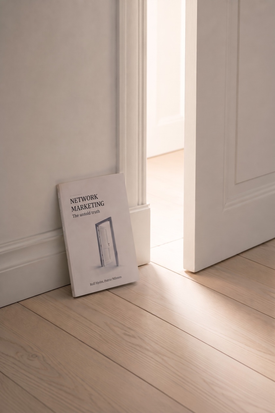 The book leaning against an open doorway with light coming through